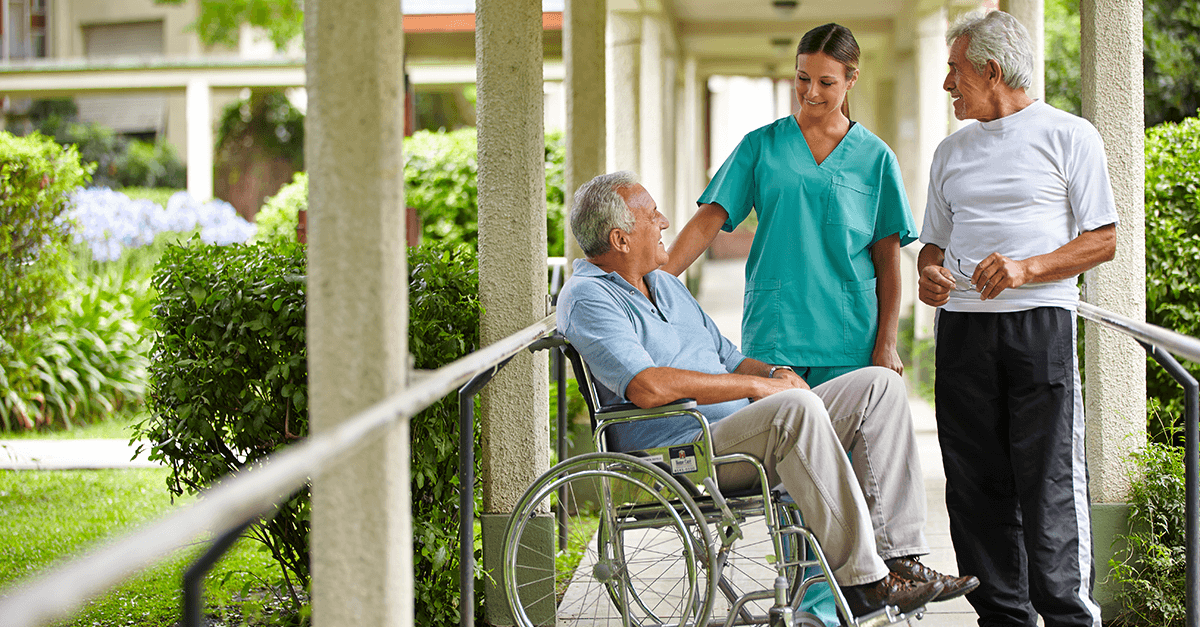 Nursing home resident with caregiver and visitor